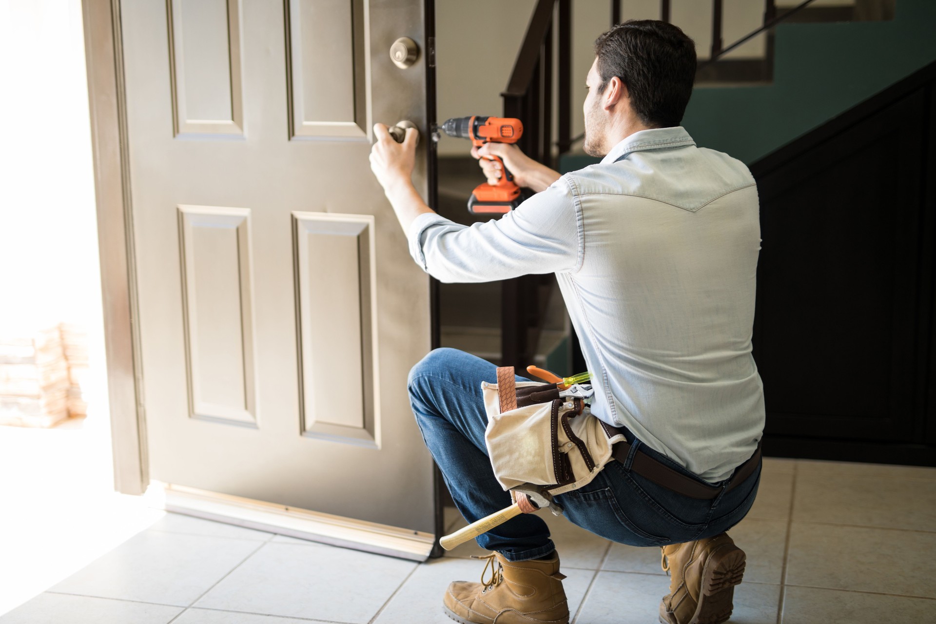 Professional fixing a door lock