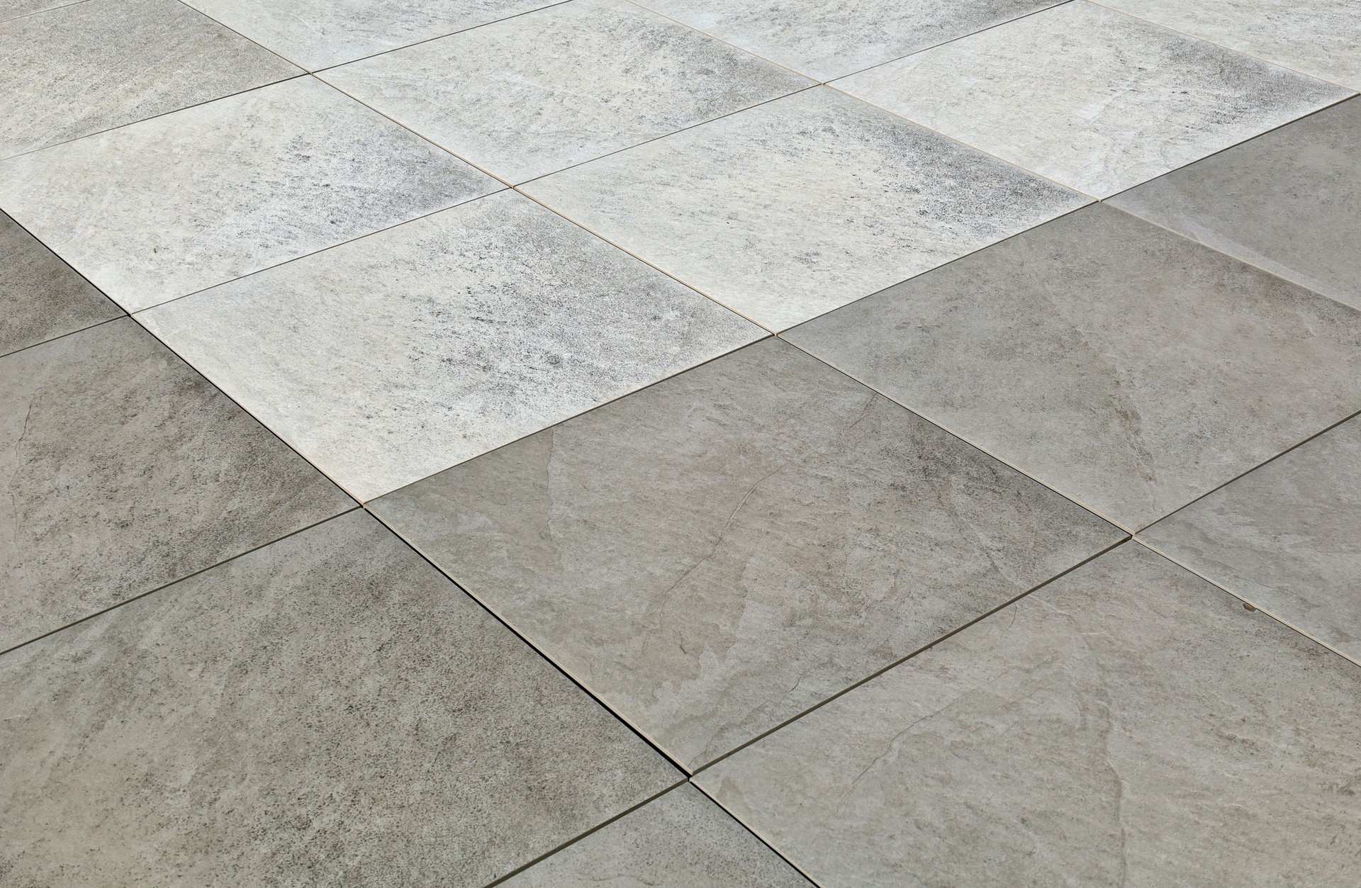 Gray and white large stoneware tiles, natural stone effect.